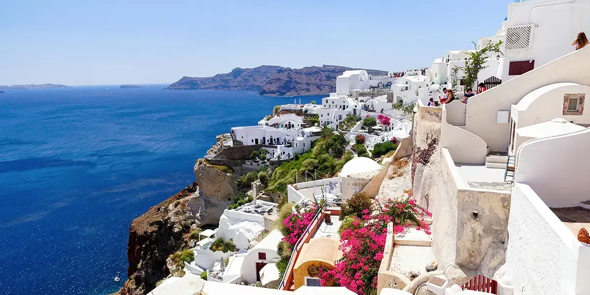 Cliffside white buildings overlooking the Aegean Sea in Santorini, Greece.