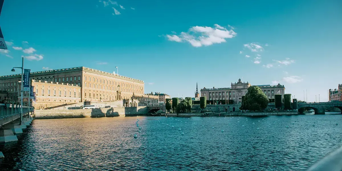 Stockholm’s Royal Palace and Parliament by the water on a clear day.