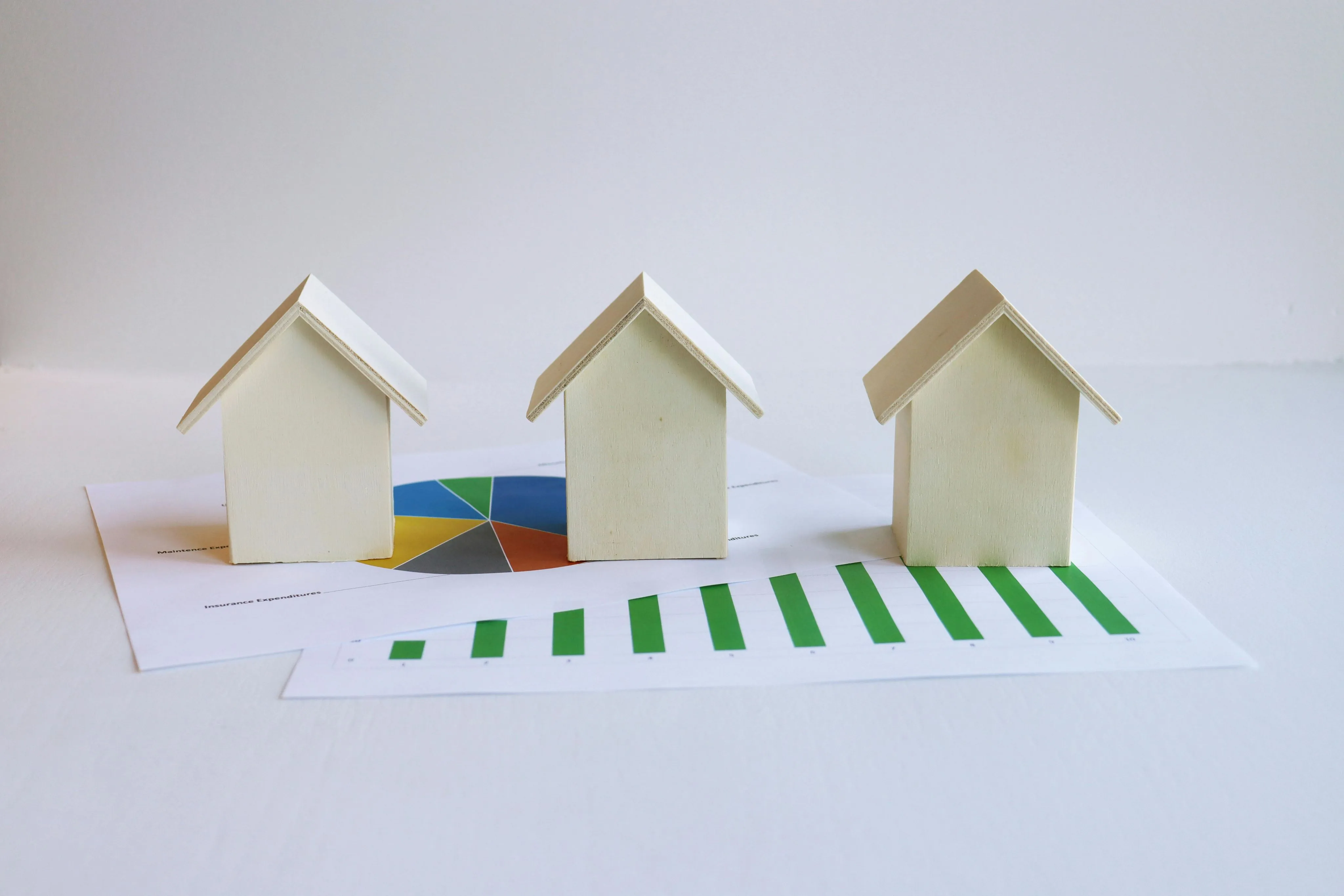 Housing Prices Wooden Model Houses and Printed Graphs