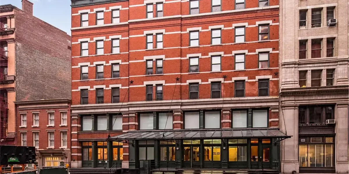 Exterior of Taylor Swift’s Tribeca compound in New York City, featuring historic red-brick facade and cast-iron storefront