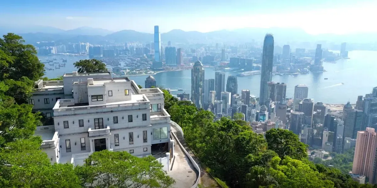 Luxury mansion on The Peak in Hong Kong with panoramic views of Victoria Harbour and city skyline surrounded by greenery