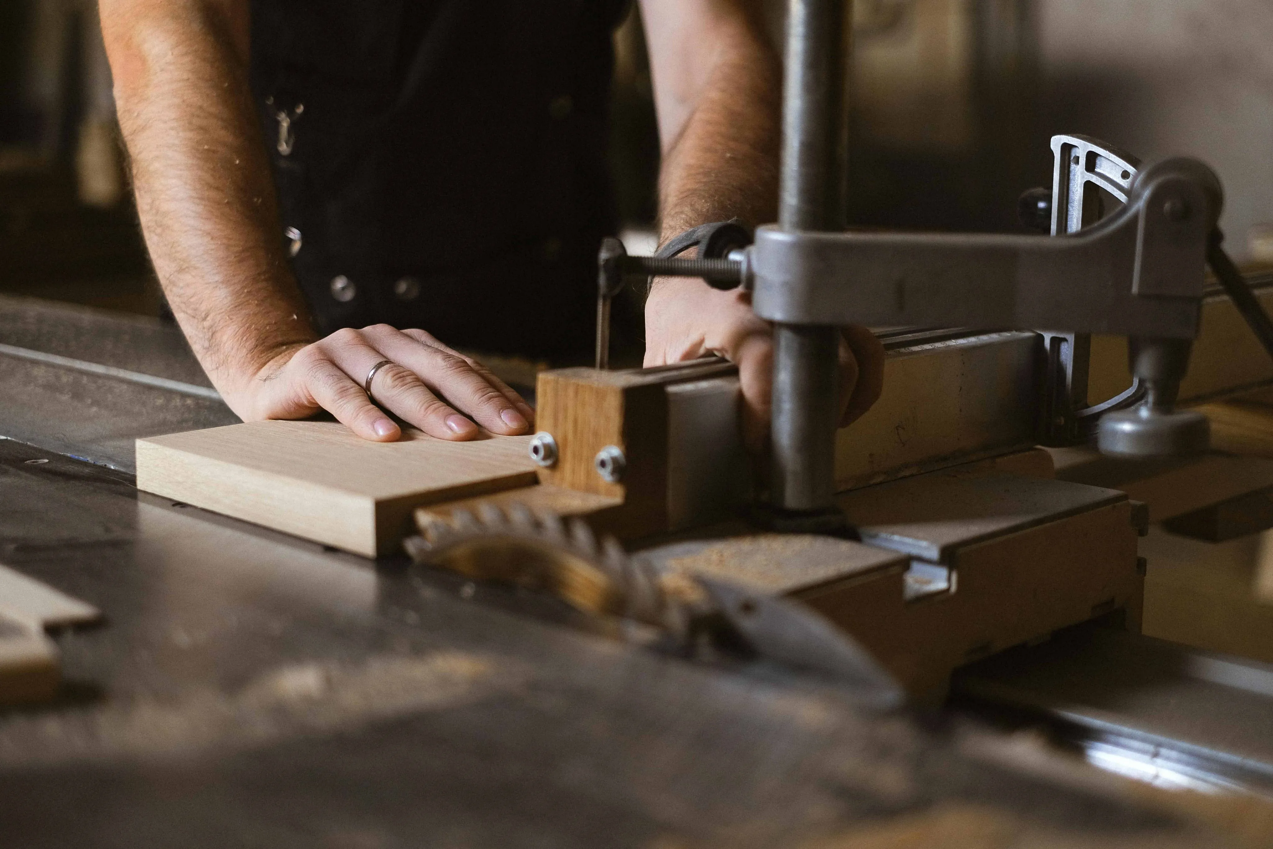Construction Technology Craftsman working with table saw in workshop