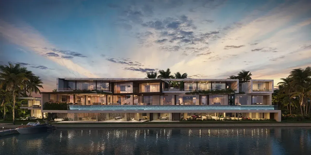 Modern waterfront estate in Palm Beach at sunset, with glass facade, infinity pool, palm trees, and luxury yacht docked nearby