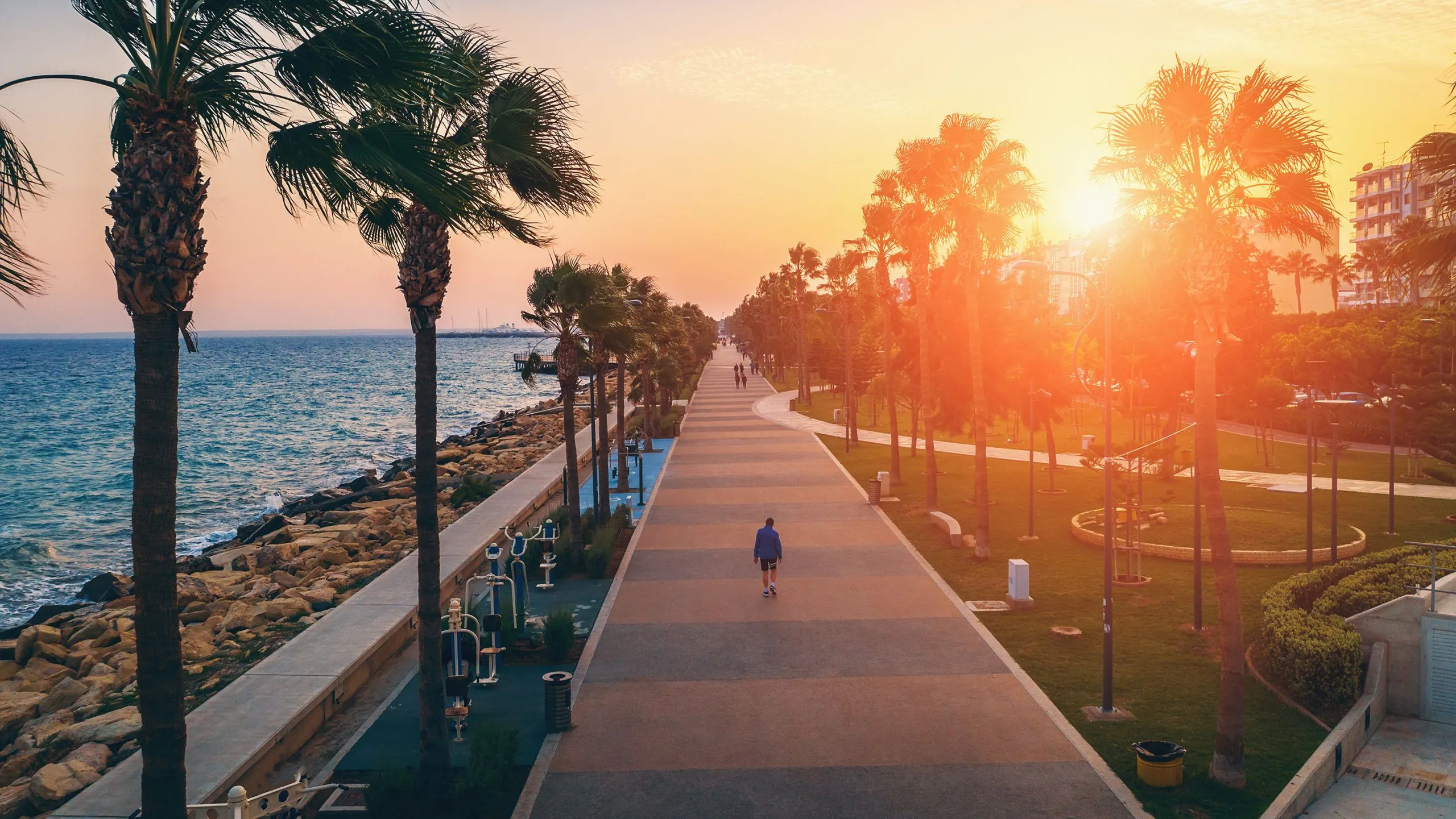 Buying Property in Cyprus A runner takes in the ocean view during a sunset workout.