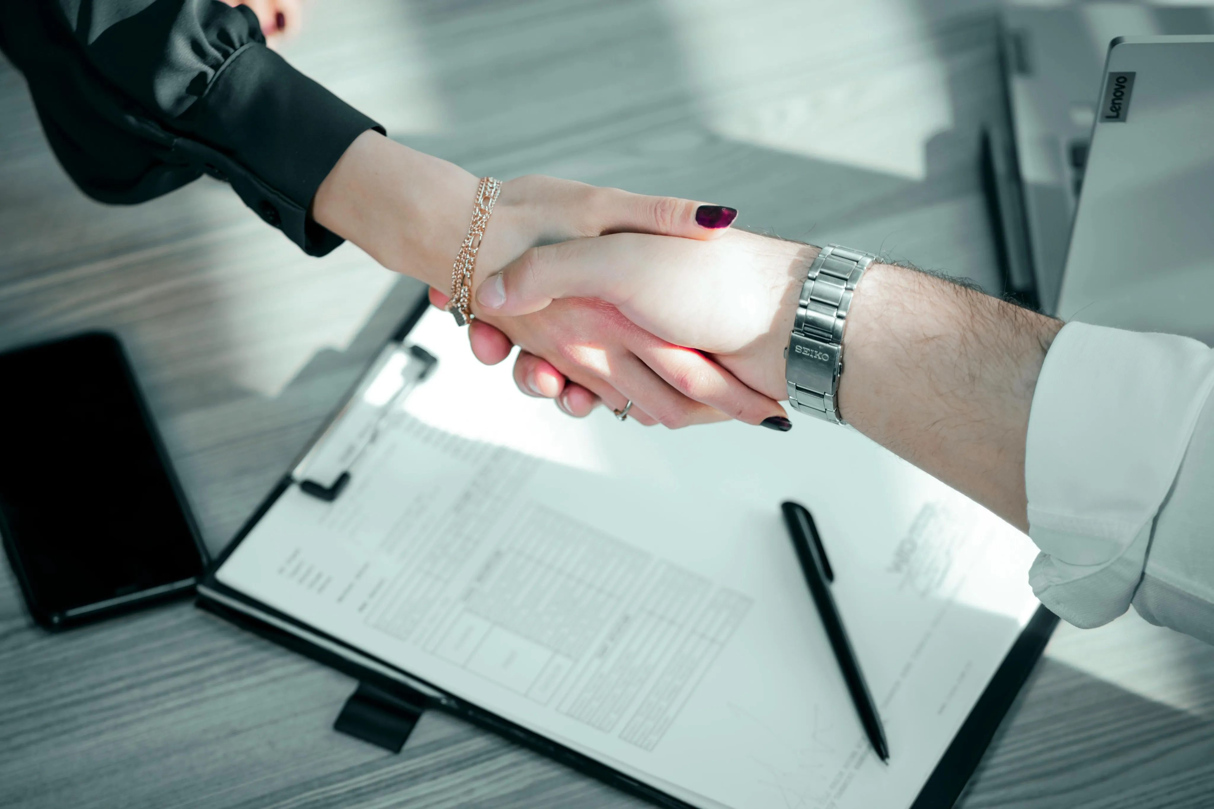 People Doing Hand Shake at the Work Desk