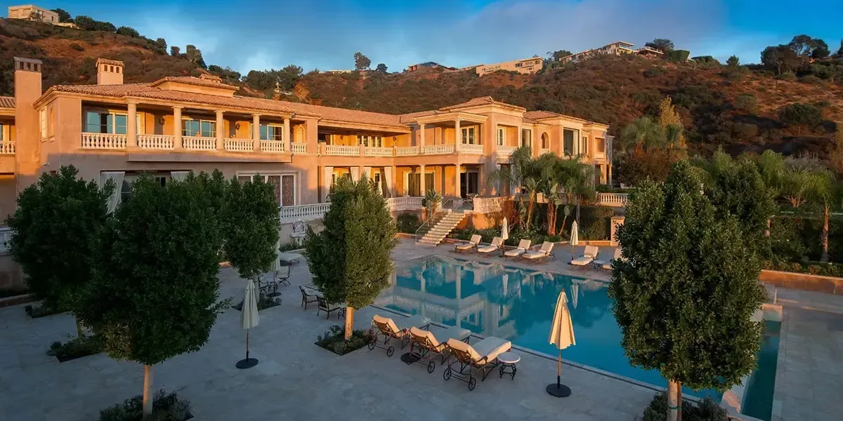 Luxury villa with large pool and sun loungers in the hills of the French Riviera at sunset