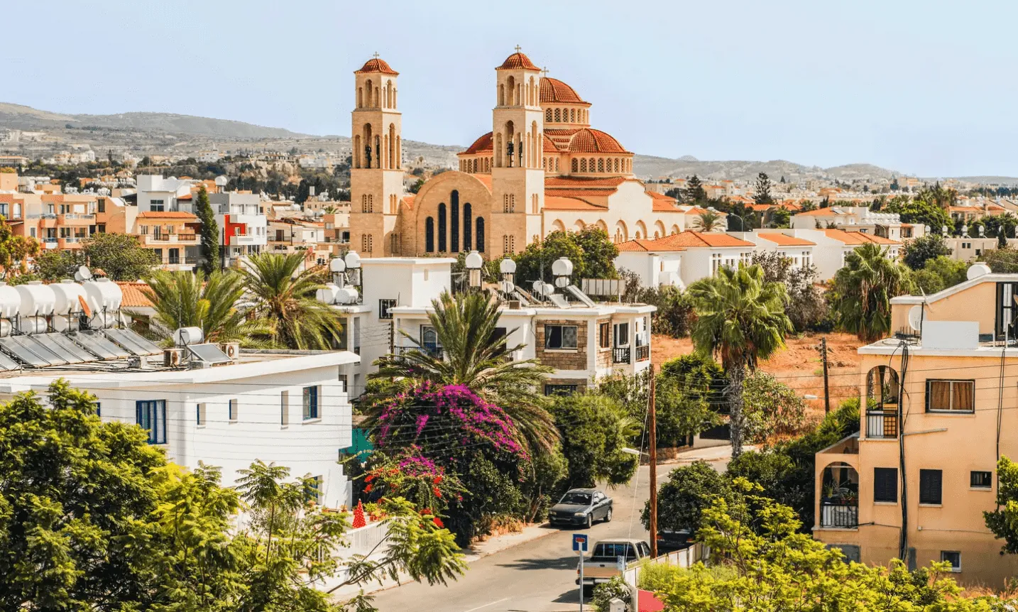 Cyprus, Paphos A whitewashed church with a red roof dominates the skyline of a traditional Paphos