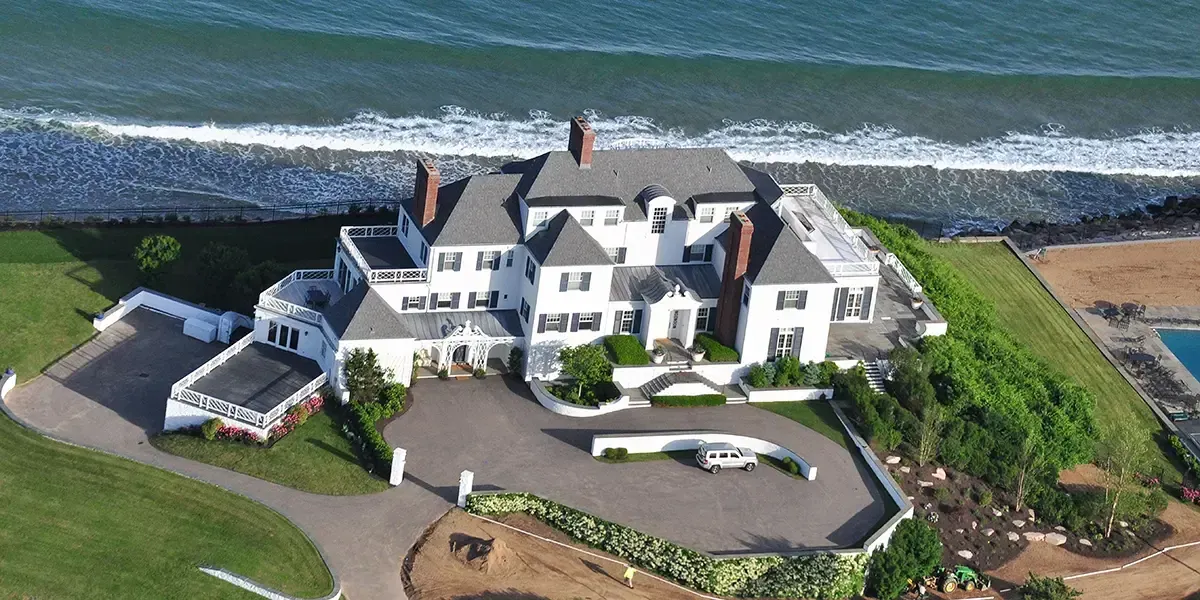 Aerial view of Taylor Swift’s $17M mansion in Watch Hill, Rhode Island, with classic architecture and oceanfront location.