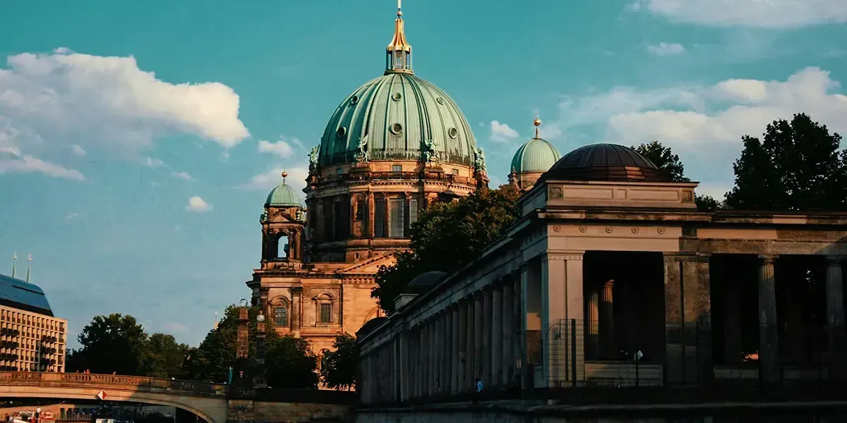 Sunset view of the Berlin Cathedral dome and nearby historic architecture.
