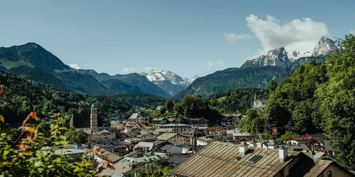 Scenic town nestled in the Bavarian Alps with traditional houses and snowy peaks.