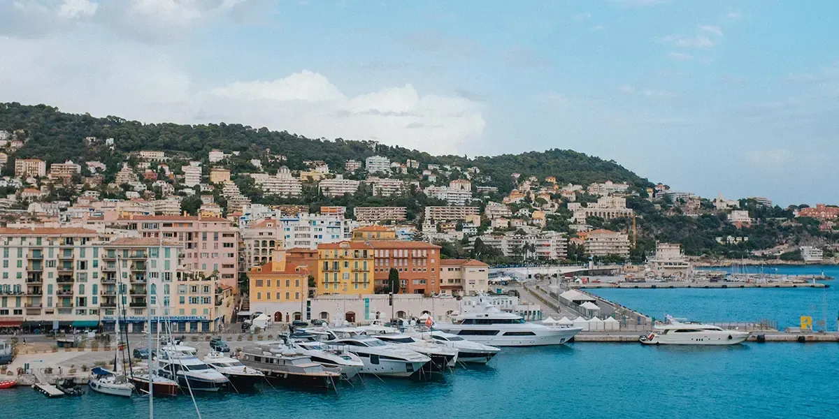 Colorful buildings and luxury yachts along the coast of Nice.