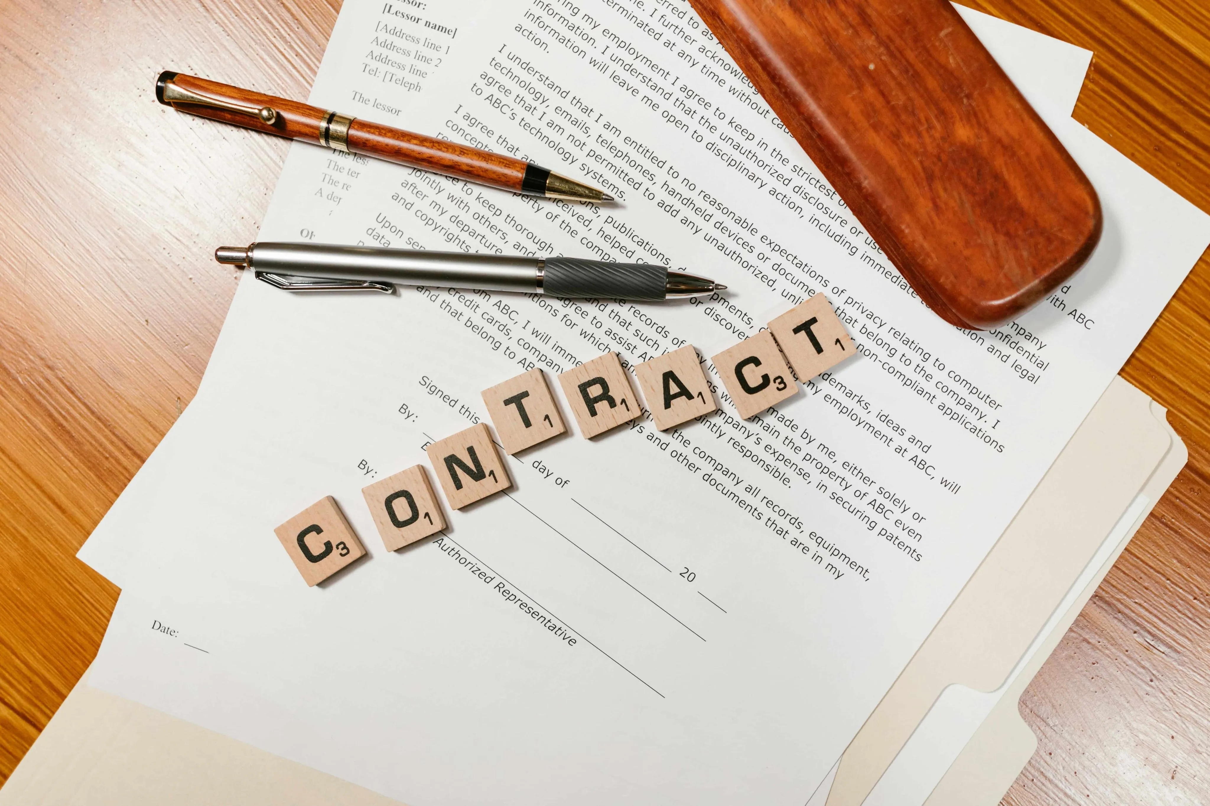 written into the contract Contract Document with Letter Tiles and Pens