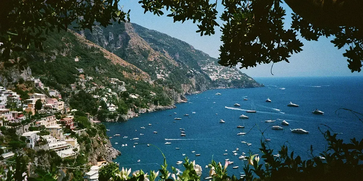 Boats and yachts on the Amalfi Coast shoreline in Italy.