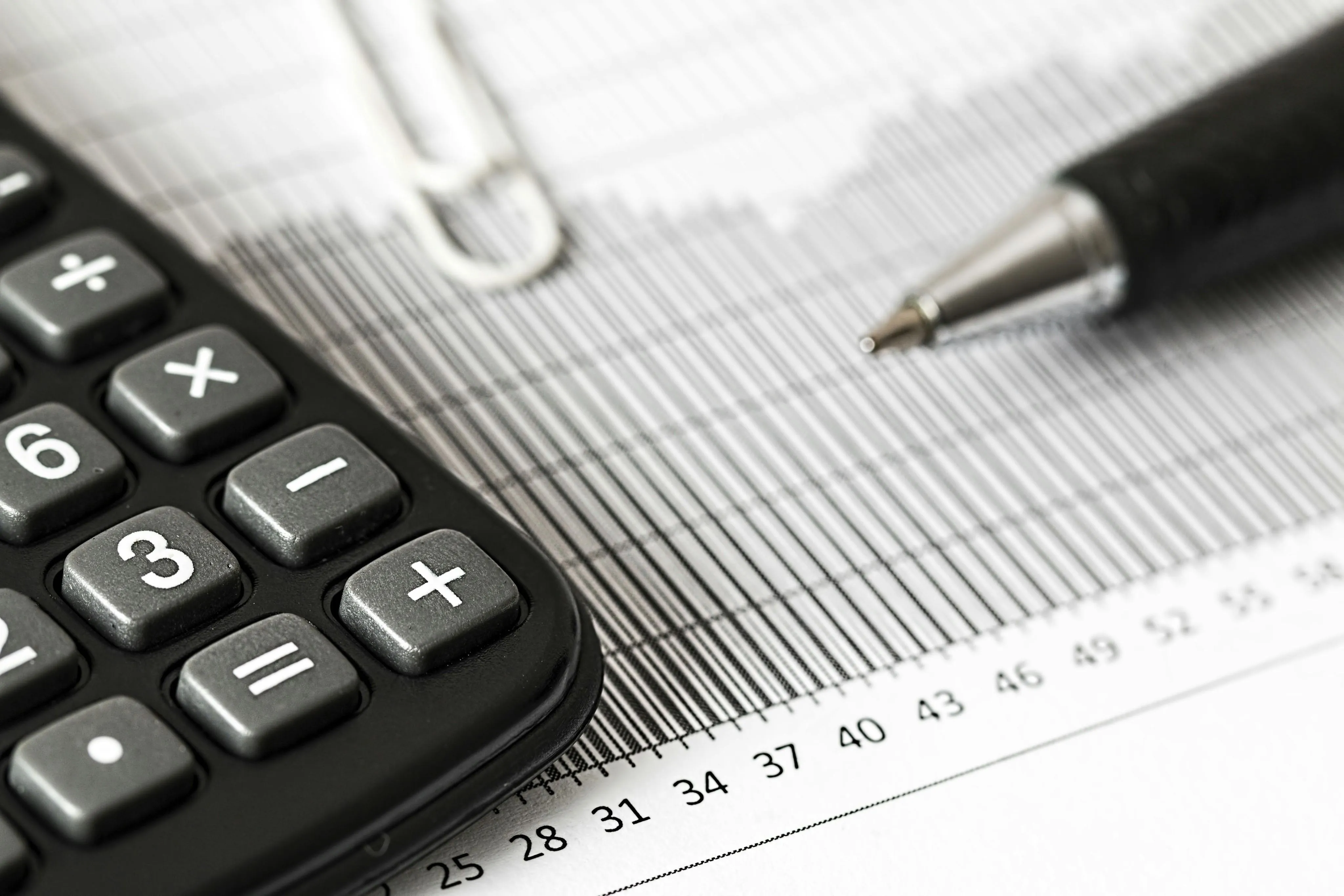A calculator and pen on a financial document.