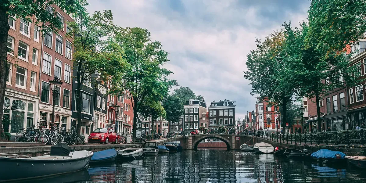 Canal with boats and historic buildings in Amsterdam, Netherlands.