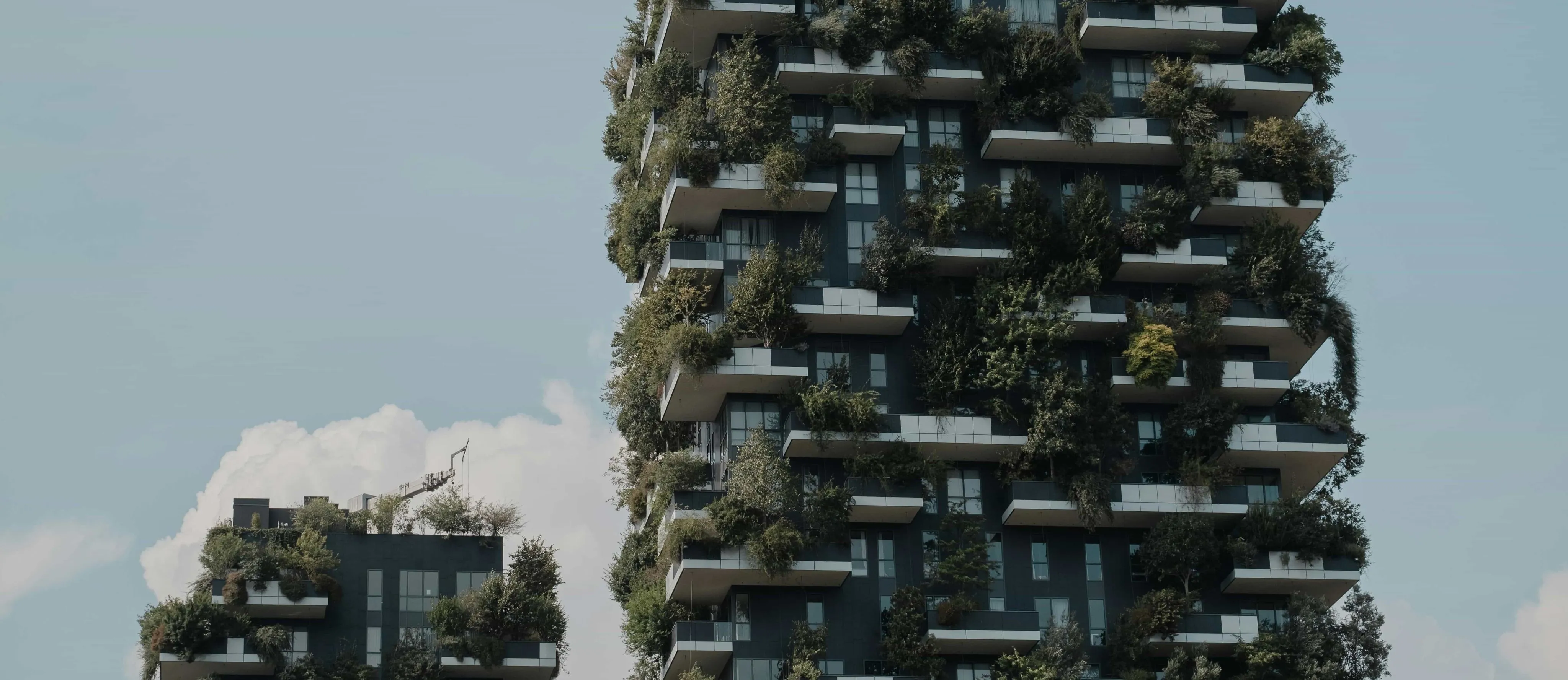 Sustainable Urban Development Two tall buildings with plants growing on them